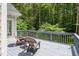 Spacious wooden deck with chairs overlooking the wooded backyard at 5809 N Hawthorne Way, Raleigh, NC 27603