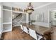 Bright dining room featuring hardwood floors, stylish chandelier, and access to the staircase at 5809 N Hawthorne Way, Raleigh, NC 27603