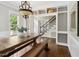 Dining room showcasing hardwood floors, chandelier, and access to the staircase and built-in shelves at 5809 N Hawthorne Way, Raleigh, NC 27603