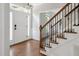 Inviting entryway with hardwood floors, staircase, and natural light, offering a warm welcome at 5809 N Hawthorne Way, Raleigh, NC 27603