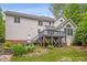 Back of house with large deck, and landscaped yard at 5809 N Hawthorne Way, Raleigh, NC 27603