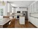 Bright kitchen with white cabinets, stainless steel appliances, and a center island at 5809 N Hawthorne Way, Raleigh, NC 27603
