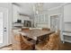 Eat-in kitchen featuring white cabinets, granite countertops, stainless appliances and a dining table at 5809 N Hawthorne Way, Raleigh, NC 27603