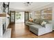 Living room with a cozy gray sectional sofa and glass doors leading to the outdoors at 5809 N Hawthorne Way, Raleigh, NC 27603