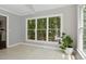 Bright sunroom with large windows, tiled floor, and a view of the wooded backyard at 5809 N Hawthorne Way, Raleigh, NC 27603