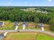 Aerial view of a neighborhood with lush greenery, manicured lawns, and beautiful trees at 70 Noble Heart Pl, Fuquay Varina, NC 27526