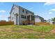 Spacious backyard featuring a wooden fence, deck, stairs, and lawn at 70 Noble Heart Pl, Fuquay Varina, NC 27526