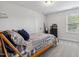 Comfortable bedroom showcasing a wooden bed frame, soft carpet, and a peaceful atmosphere at 70 Noble Heart Pl, Fuquay Varina, NC 27526