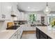 Well-lit kitchen with white cabinets, stainless steel appliances, and a functional layout at 70 Noble Heart Pl, Fuquay Varina, NC 27526