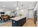 Open-concept kitchen view with a large island, with dining and living spaces in view at 70 Noble Heart Pl, Fuquay Varina, NC 27526