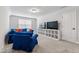 Cozy living area boasts plush seating, a wall-mounted TV, and ample storage for entertainment at 70 Noble Heart Pl, Fuquay Varina, NC 27526
