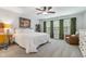 Spacious primary bedroom with a ceiling fan, large windows, and plush furnishings at 70 Noble Heart Pl, Fuquay Varina, NC 27526