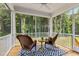 Inviting screened porch with rocking chairs and serene wooded views, perfect for relaxation and outdoor living at 70 Noble Heart Pl, Fuquay Varina, NC 27526
