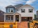 Two-story home featuring blue and white siding, a brick entryway, and an attached garage at 756 Deschutes Dr, Garner, NC 27529