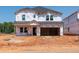 Exterior shot of an incomplete two-story home with Tyvek wrap, ready for customization at 760 Deschutes Dr, Garner, NC 27529