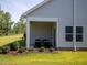 Covered patio perfect for outdoor lounging features exterior access to the backyard and manicured lawn at 760 Deschutes Dr, Garner, NC 27529