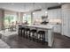Spacious eat-in kitchen with granite island, seating, and views to the dining area and backyard at 816 Walker Ridge Way, Willow Springs, NC 27592