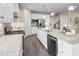 Open kitchen with stainless steel appliances, granite countertops, a center island, and dark wood flooring at 816 Walker Ridge Way, Willow Springs, NC 27592
