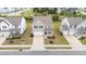 Aerial view of gray two-story home with a driveway and two-car garage in a neighborhood at 908 Adelphia Rd, Fuquay Varina, NC 27526