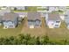 Aerial view of a gray two-story home with a well-maintained lawn in a suburban neighborhood at 908 Adelphia Rd, Fuquay Varina, NC 27526
