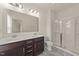 Bathroom featuring a double sink vanity, a toilet, and glass enclosed shower at 908 Adelphia Rd, Fuquay Varina, NC 27526