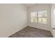 Bright bedroom with two windows and wood-look flooring that enhances the natural light at 908 Adelphia Rd, Fuquay Varina, NC 27526