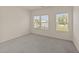 Bedroom has neutral carpet, white walls, and two windows allowing natural light to fill the space at 908 Adelphia Rd, Fuquay Varina, NC 27526