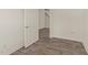 A bedroom featuring wood-look flooring and white walls with an entry door at 908 Adelphia Rd, Fuquay Varina, NC 27526