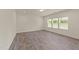 Bright and airy bedroom with large windows, neutral walls, and wood-look flooring at 908 Adelphia Rd, Fuquay Varina, NC 27526