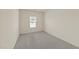 Bright bedroom with neutral carpet, a window for natural light, and electrical outlets at 908 Adelphia Rd, Fuquay Varina, NC 27526