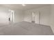Large bedroom with neutral carpet, and open doorway to the closet and hallway at 908 Adelphia Rd, Fuquay Varina, NC 27526