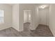 An entryway featuring wood-look flooring, white walls and entry door to another room at 908 Adelphia Rd, Fuquay Varina, NC 27526