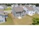 Backyard view of two-story house featuring an open yard with lush green lawn and easy access to other homes at 908 Adelphia Rd, Fuquay Varina, NC 27526
