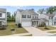 Two-story home with gray siding, black shutters, a driveway, and a two-car garage at 908 Adelphia Rd, Fuquay Varina, NC 27526