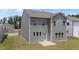 Backyard view of two-story house featuring an open yard with lush green lawn and concrete patio at 908 Adelphia Rd, Fuquay Varina, NC 27526