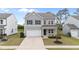 Charming two-story home with gray siding, attached garage and well-maintained lawn in a suburban neighborhood at 908 Adelphia Rd, Fuquay Varina, NC 27526