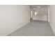 Hallway with neutral carpet, multiple light fixtures, and doorways leading to other rooms at 908 Adelphia Rd, Fuquay Varina, NC 27526