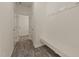 Hallway with a built-in bench and coat hooks, featuring wood-look floors at 908 Adelphia Rd, Fuquay Varina, NC 27526