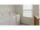 The laundry room has a side-by-side washer and dryer with a window for natural light at 908 Adelphia Rd, Fuquay Varina, NC 27526