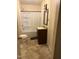 Bathroom with a single sink vanity, toilet, and tub/shower combo with white shower curtain at 911 Holloway St, Durham, NC 27701