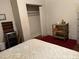 Bedroom with a closet and a small wooden table with flowers. The floor is covered in red carpet at 911 Holloway St, Durham, NC 27701