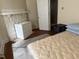 Bedroom with fireplace, mattress, and dresser with a view to the hallway at 911 Holloway St, Durham, NC 27701