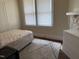 Bright bedroom with a twin bed, gray rug, and a white dresser at 911 Holloway St, Durham, NC 27701