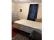 Bedroom with carpet, a window with dark curtains, and a large mattress at 911 Holloway St, Durham, NC 27701