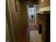 Hallway features stone fireplace, hardwood floors, and opens to other rooms at 911 Holloway St, Durham, NC 27701