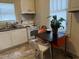 Kitchen with linoleum flooring, white cabinets, a table with chairs and a window at 911 Holloway St, Durham, NC 27701