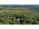 Aerial view of a home surrounded by lush forestry with mature trees at 92 Summer Dawn, Pittsboro, NC 27312
