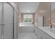 Clean bathroom with bathtub, shower, white fixtures, and neutral color scheme at 92 Summer Dawn, Pittsboro, NC 27312
