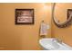 Clean half bath featuring a modern sink, decorative mirror, and neutral tones at 92 Summer Dawn, Pittsboro, NC 27312