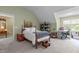 Large bedroom with a workspace, bed, and natural light from surrounding windows at 92 Summer Dawn, Pittsboro, NC 27312